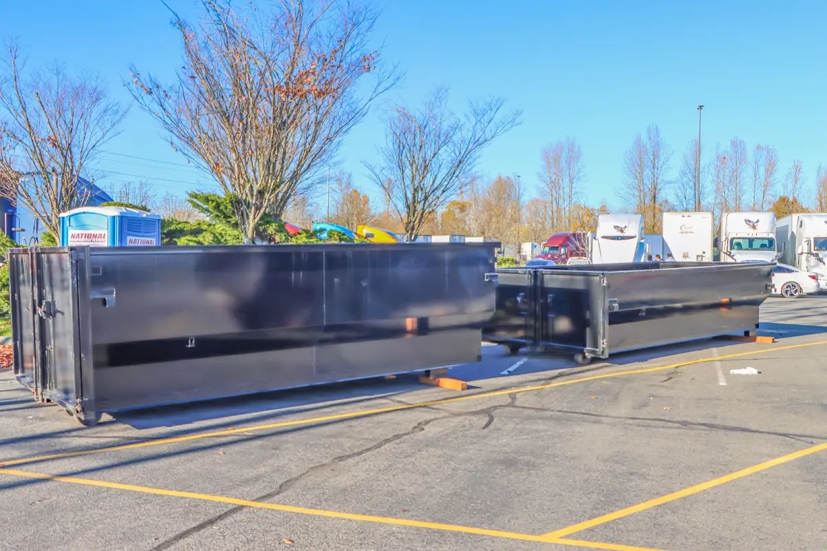 Professional dumpster rental service with roll-off container on residential driveway in Meadow Woods